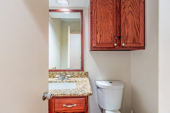 Half bathroom featuring vanity and a textured ceiling | Image 14