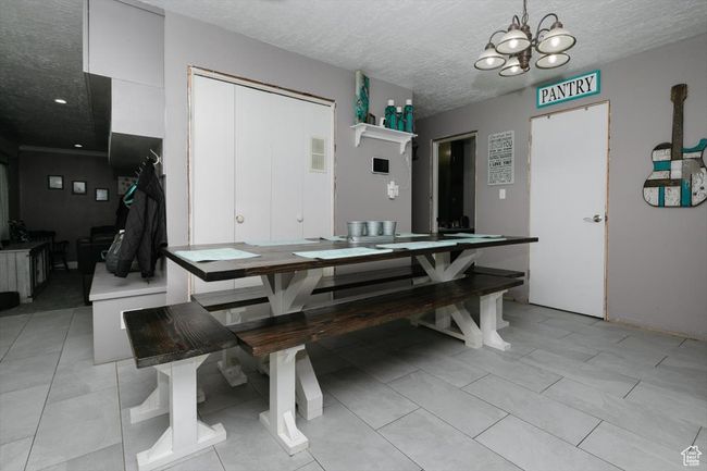 Dining space with a textured ceiling and an inviting chandelier | Image 9