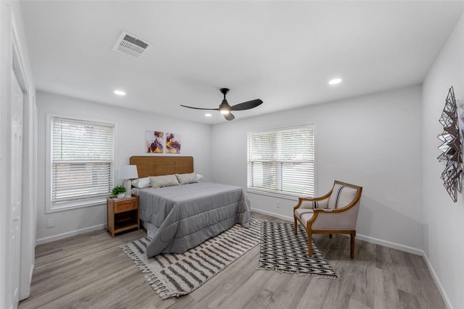 Bedroom featuring wood finished floors, recessed lighting, and a ceiling fan | Image 11