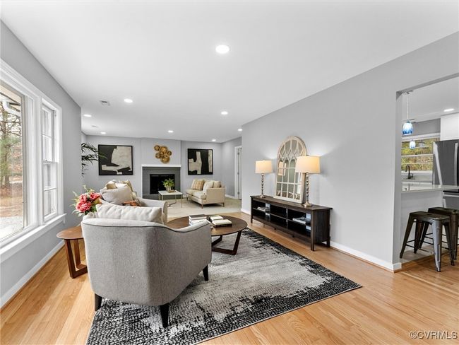Living area featuring recessed lighting, a fireplace, light wood-style flooring, and baseboards | Image 8