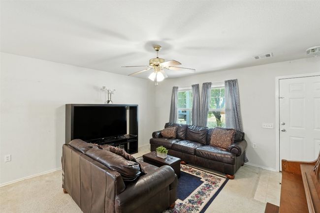 Living room featuring light carpet and a ceiling fan | Image 8