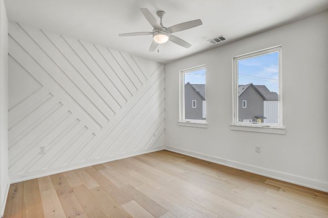 Spare room featuring baseboards, light wood finished floors, and a ceiling fan | Image 15