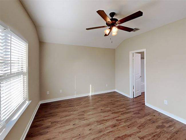 Spare room featuring lofted ceiling, a ceiling fan, and wood finished floors | Image 13