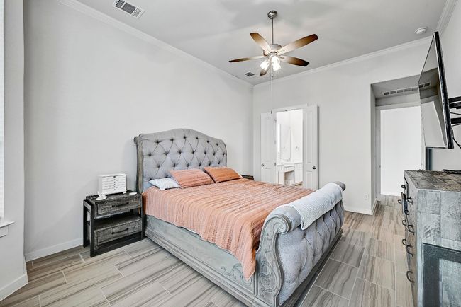 Natural light fills the owner’s suite through large windows, creating a peaceful atmosphere for rest and rejuvenation. | Image 13
