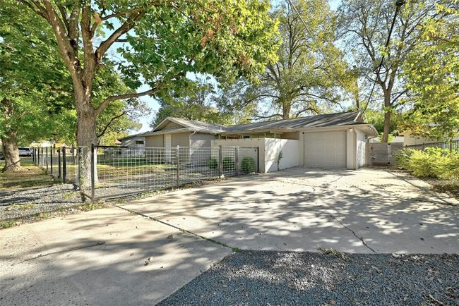 Xeriscape features surround the driveway that guides you to the attached 1-car garage. | Image 4