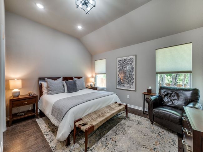 Bedroom featuring multiple windows, wood finished floors, baseboards, recessed lighting, and vaulted ceiling | Image 17