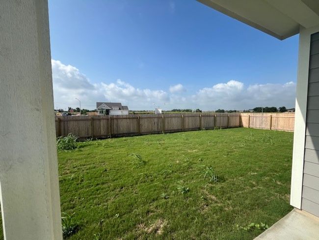 View of fenced backyard | Image 11