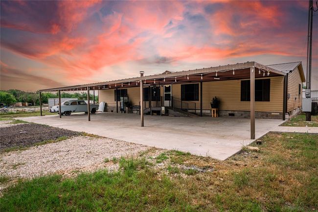 Front house at dusk featuring a carport | Image 2