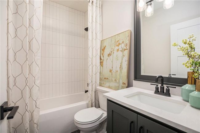 Full bath featuring shower / tub combo with curtain and vanity | Image 32
