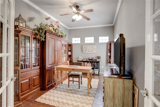 This bright sudy features high ceilings, engineered hardwood floors, and plenty of natural light from the upper windows. | Image 6