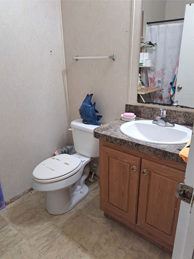 Bathroom with vanity and a shower with curtain | Image 12