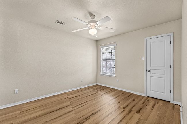 Unfurnished room featuring light wood-style flooring, a ceiling fan, and a textured ceiling | Image 26