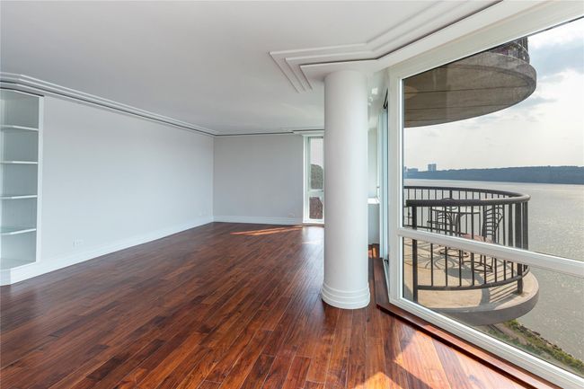 Empty room with hardwood / wood-style flooring and decorative columns | Image 8