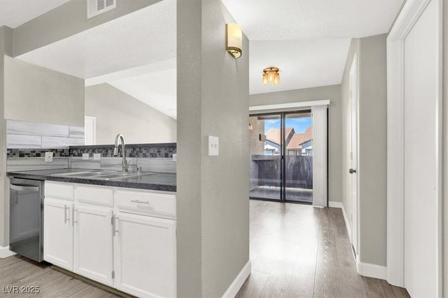 Kitchen featuring a sink, visible vents, backsplash, light wood-style floors, and dishwasher | Image 10