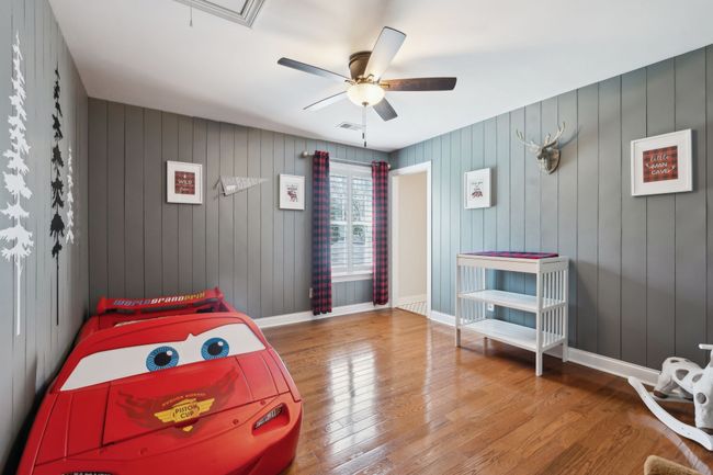 Adorable themed bedroom with custom shiplap walls and walk-in closet. | Image 29