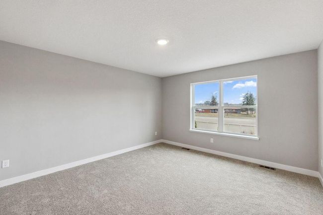 Primary bedroom with walk-in closet and private bath. Model home. Options and colors will vary. | Image 20