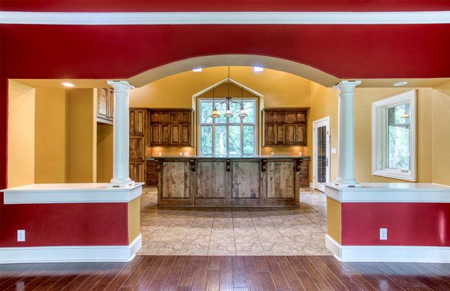 Kitchen showcasing grand entry with columns. | Image 10