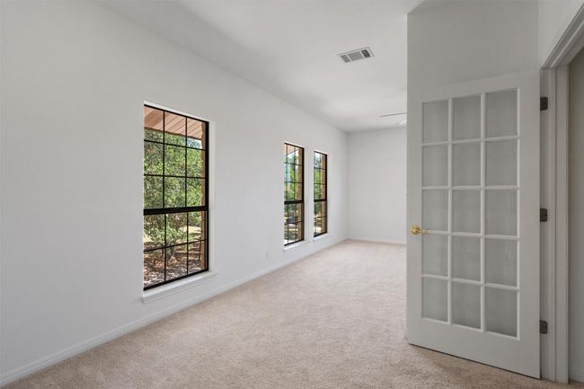 Carpeted spare room featuring baseboards and visible vents | Image 24
