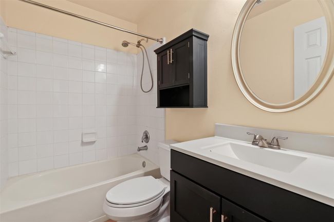 The secondary bathroom features an updated vanity with large sink and tub/shower combo. | Image 20