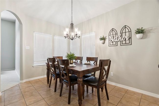 The breakfast area is spacious and can accommodate a small or large table. New light fixture. | Image 11