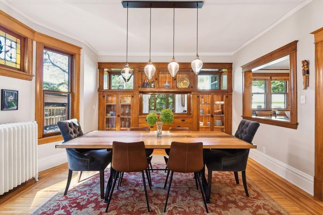 Dining room features an original built-in buffet with cabinets. Lighting was added to the interior of the glass cabinets by seller. Don't miss the beautiful stain glassed window! | Image 8