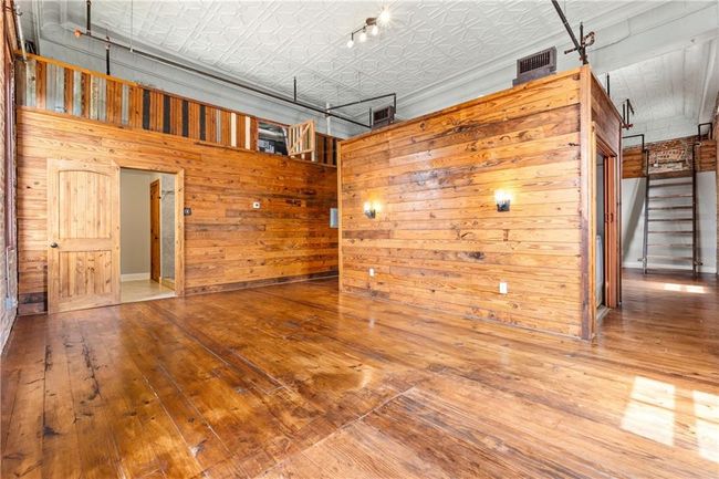 Garage featuring wooden walls and an ornate ceiling | Image 12