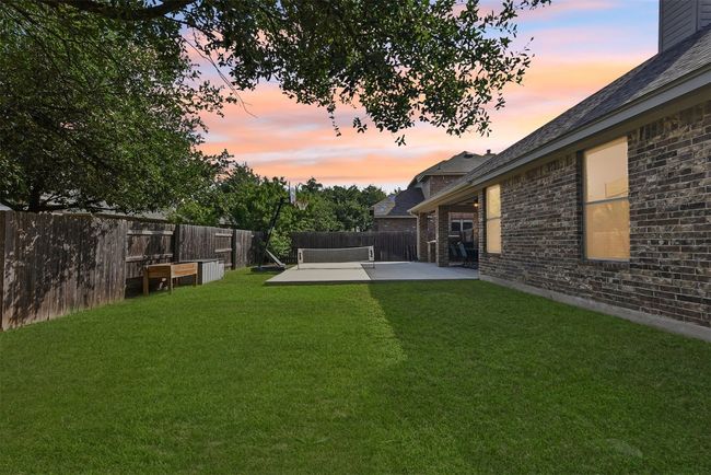 Mature landscaping and a spacious lawn create a perfect blend of beauty and function for everyday outdoor living *Virtual twilight/grass | Image 35
