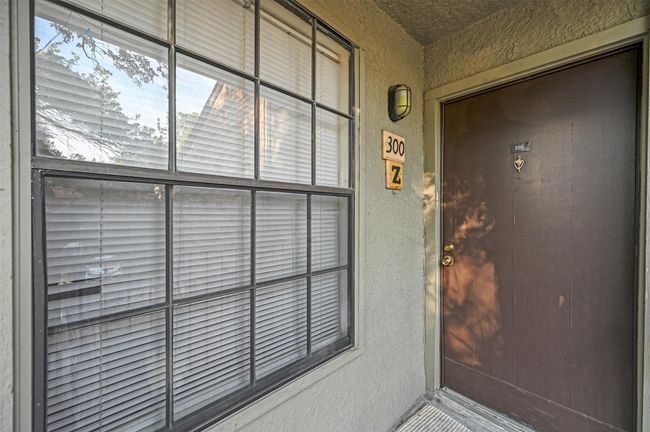 Doorway to property featuring stucco siding | Image 15