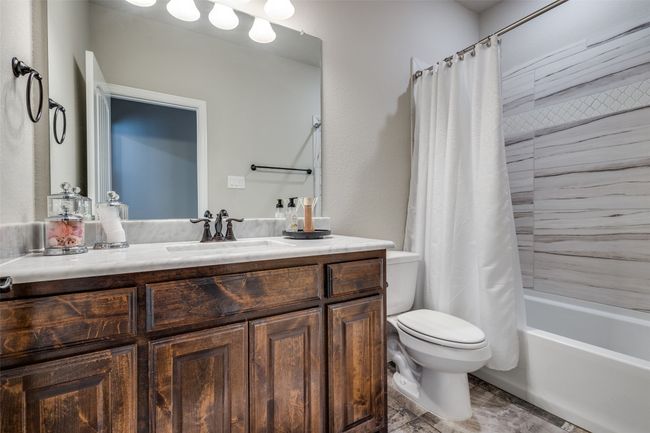 Full bathroom featuring shower / tub combo, vanity, and toilet | Image 30