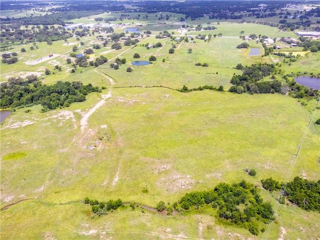 Aerial overview of property's location featuring a large body of water and rural landscape | Image 8