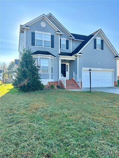 View of property with a front yard and a garage | Image 2