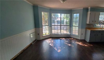 Unfurnished dining area with ornamental molding, sink, and dark hardwood / wood-style floors | Image 3