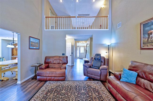 Enjoy a stunning view from the loft overlooking the spacious family room. | Image 10