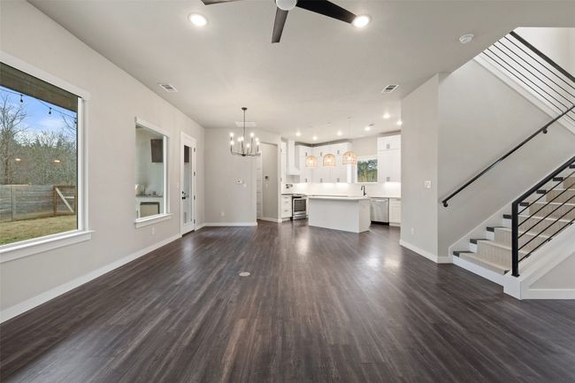 open floor plan ceiling fan with notable chandelier | Image 19