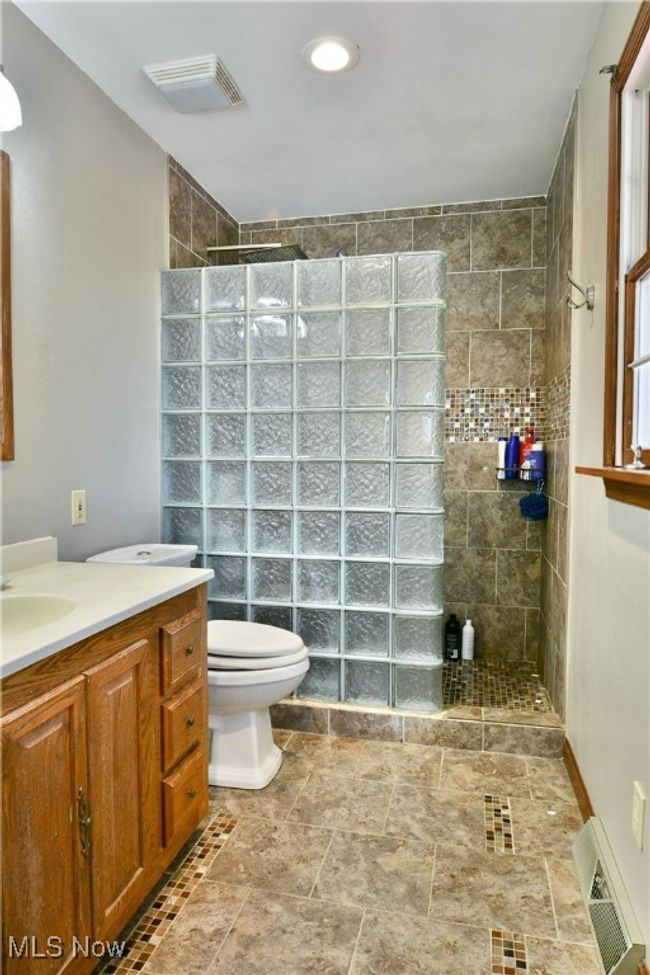 Bathroom featuring visible vents, vanity, and walk in shower | Image 43