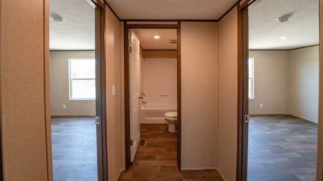 Hall with dark wood finished floors, a textured ceiling, and recessed lighting | Image 20