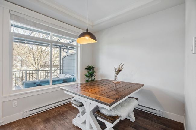 Dining space with baseboard heating, dark wood-type flooring, and baseboards | Image 14