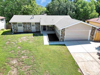 Ranch-style home with a front yard and a garage | Image 2