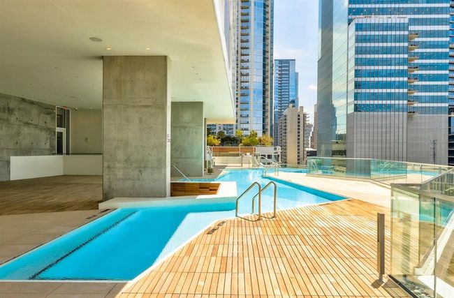Community pool featuring a patio, pingpong tables, entertainment area for watching sports by the pool | Image 23