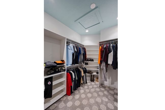 Spacious closet with attic access and carpet flooring | Image 39