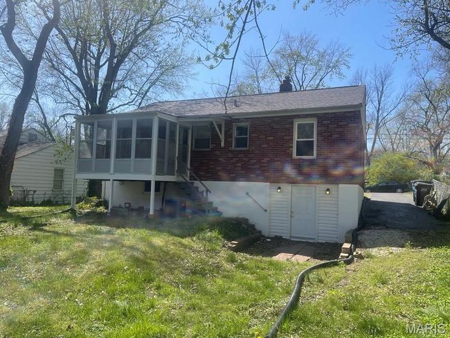 Back of house featuring a sunroom, stairs, and a lawn | Image 26