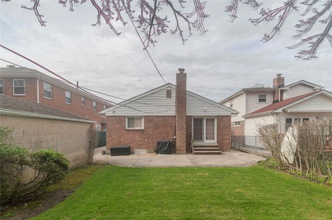Back of property featuring a lawn, a patio, entry steps, fence, and brick siding | Image 31