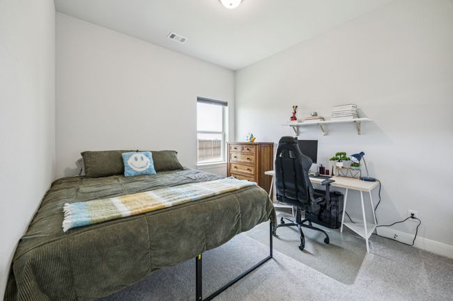 Bedroom featuring baseboards, carpet, and a desk | Image 9