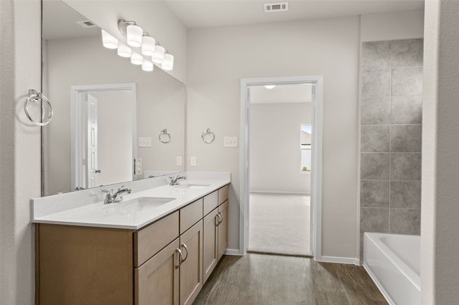Full bath with a sink, visible vents, double vanity, and wood finished floors | Image 18