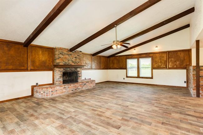 Living Area Features Wood Burning Fireplace and Beamed Ceiling | Image 20