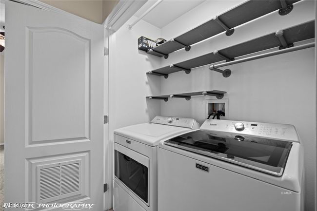 Washroom with separate washer and dryer, visible vents, and laundry area | Image 18