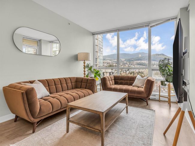 Living area featuring expansive windows, baseboards, a healthy amount of sunlight, and wood finished floors | Image 6