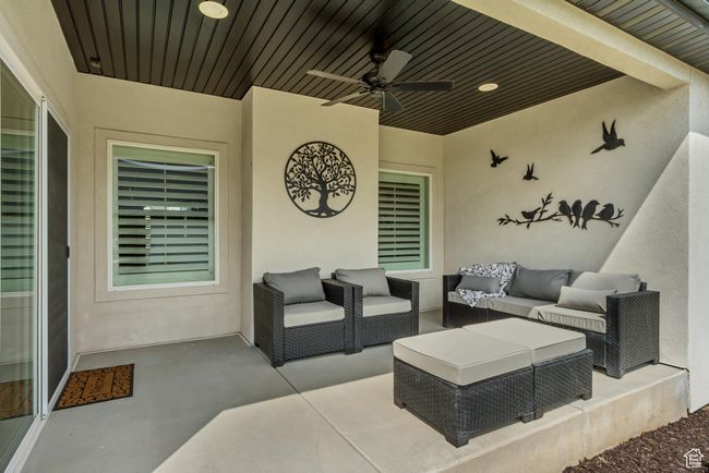 View of patio featuring an outdoor living space and ceiling fan | Image 28