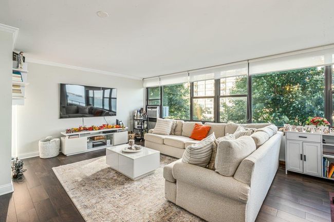 Living area with crown molding, dark wood finished floors, and plenty of natural light | Image 12