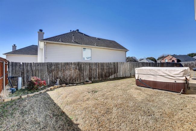 View of yard featuring a fenced backyard and a hot tub | Image 7